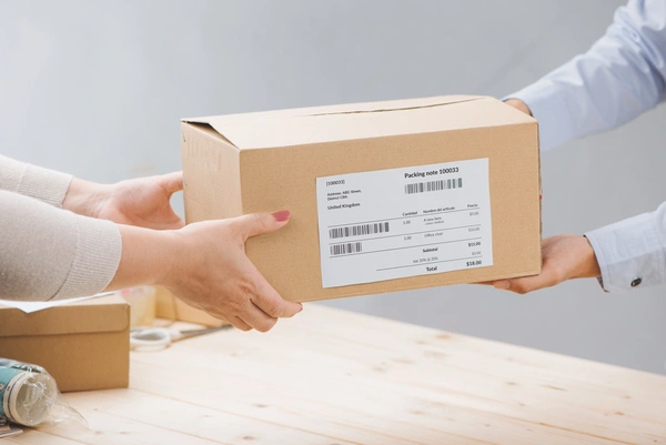  Woman - Receiving - Package - From - Delivery - Man